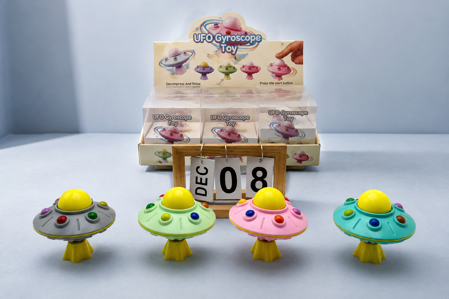 UFO gyroscope spinning toy retail display with four color options showing a simple motion-based novelty toy