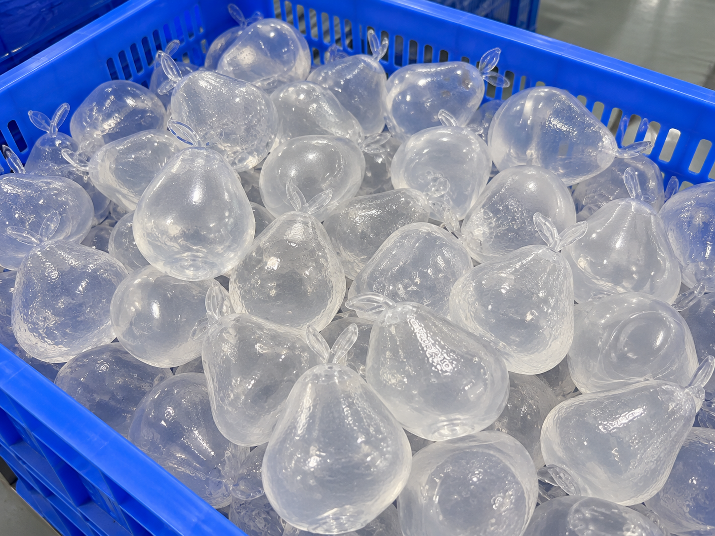 Clear TPR squeeze toy shells in a factory production crate