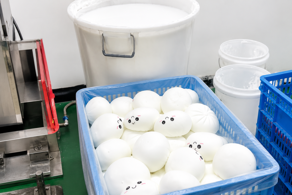 Squishy toy mold development with white molded squishy samples in a factory production area